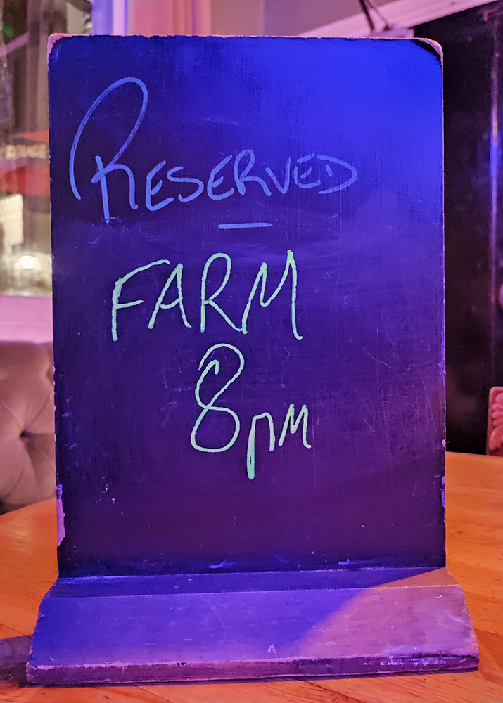 Reserved Farm 8pm on a small chalk sign on a pub table